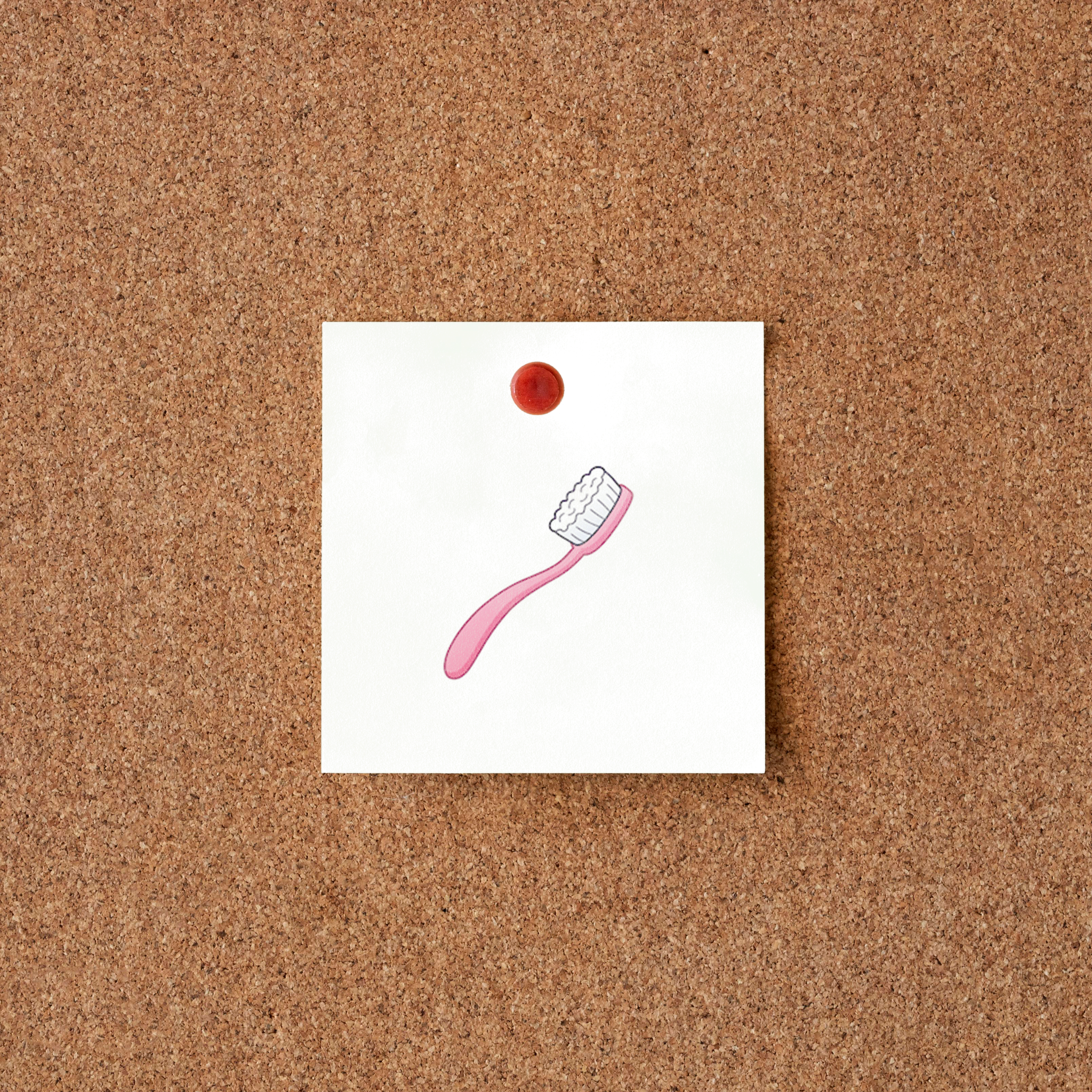 Pictogramme brosse a dent rose sur tableau en liège