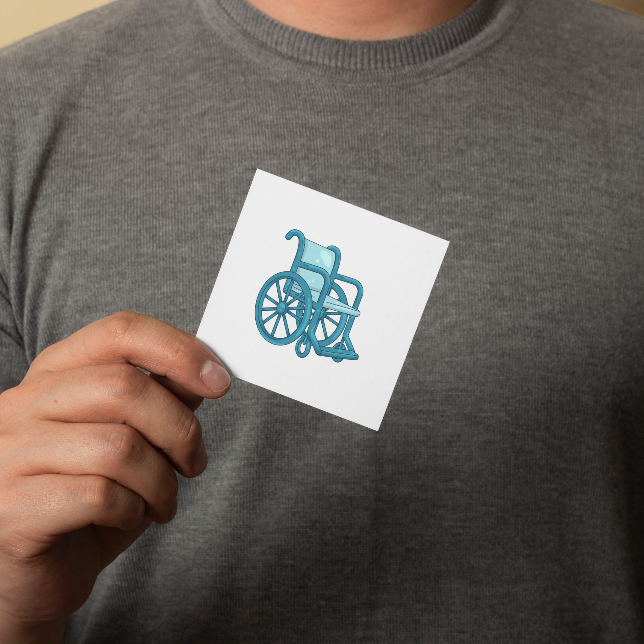 Etiquette pictogramme fauteuil roulant dans une main 